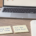 Calm wooden desk with three yellow sticky notes reading "Win = data, not proof", "Same size next trade" and "Set the limit first", beside a notebook, blue Bic pen, coffee and a laptop showing a candlestick chart.