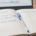 A trading journal open on a desk with a handwritten note reading grade the process, not the P&L