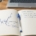 A hand-drawn candlestick chart in a journal with a stop placed beyond the swing low